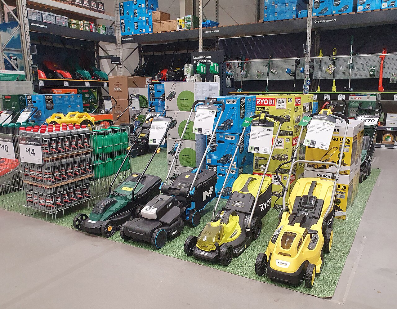 Rows of assembled lawn mowers lined up on display at a home-improvement store